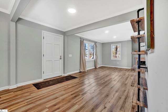 entrance foyer with crown molding and light hardwood / wood-style flooring