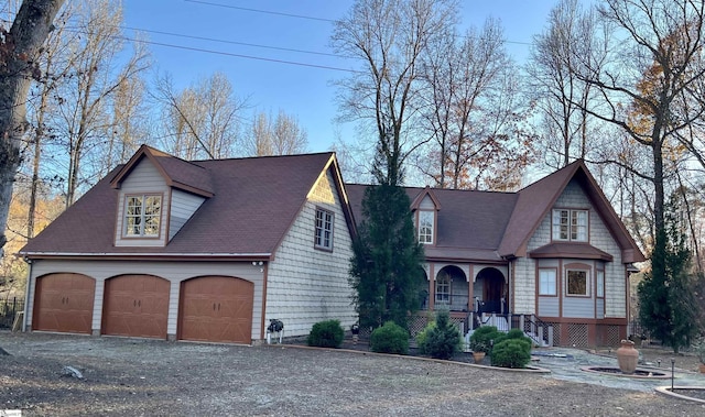 view of front facade with covered porch and a garage