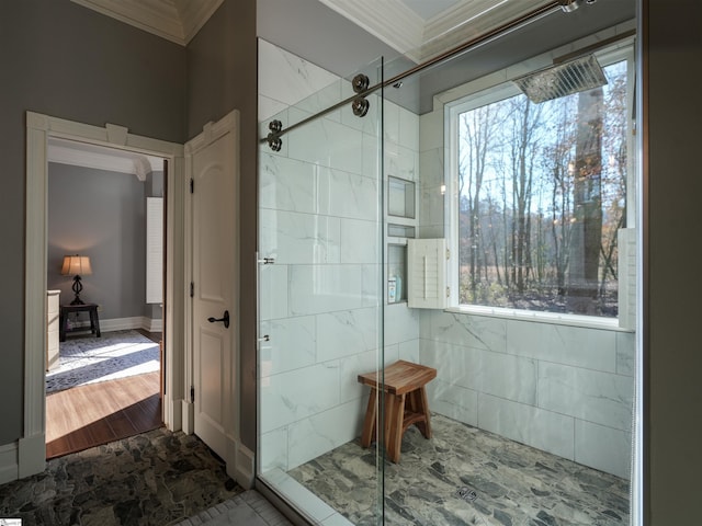 bathroom with a tile shower, wood-type flooring, and crown molding