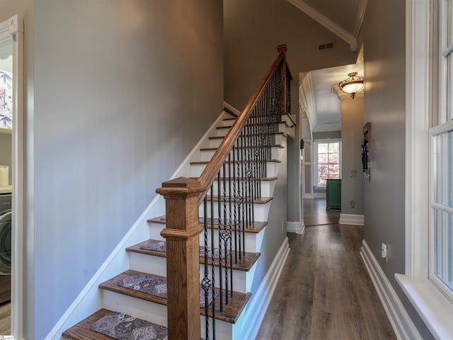 staircase with hardwood / wood-style floors and crown molding