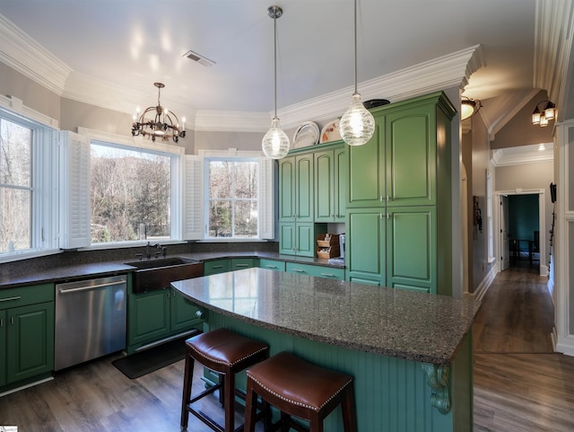 kitchen with dark wood-type flooring, plenty of natural light, stainless steel dishwasher, and green cabinetry