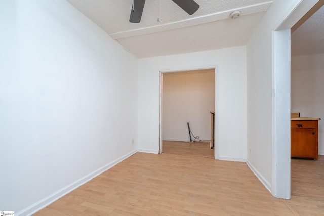 interior space with ceiling fan, light hardwood / wood-style floors, and a textured ceiling