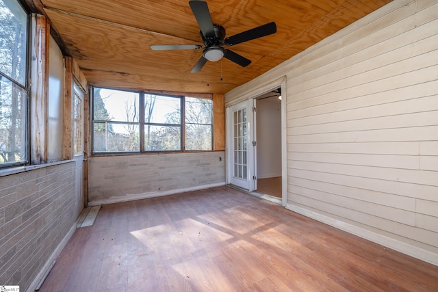 unfurnished sunroom featuring ceiling fan and wooden ceiling