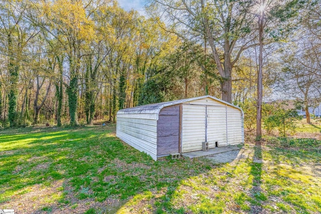 view of outbuilding featuring a lawn