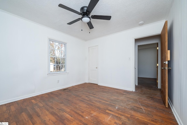 unfurnished bedroom with a textured ceiling, dark hardwood / wood-style flooring, and ceiling fan