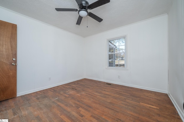 unfurnished room featuring ceiling fan, dark hardwood / wood-style flooring, a textured ceiling, and crown molding