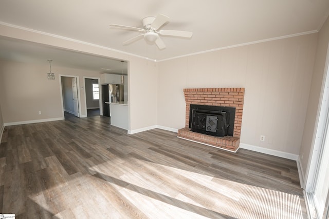 unfurnished living room featuring ceiling fan, dark hardwood / wood-style flooring, and crown molding