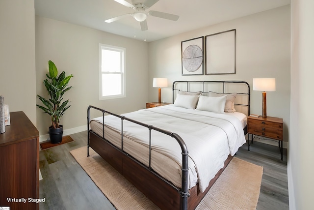 bedroom featuring ceiling fan and dark wood-type flooring