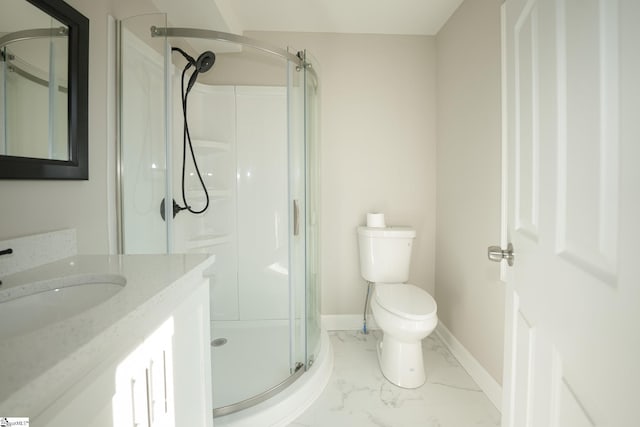 bathroom featuring vanity, a shower with shower door, and toilet