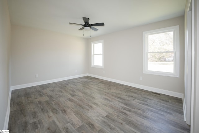 spare room featuring ceiling fan and dark wood-type flooring