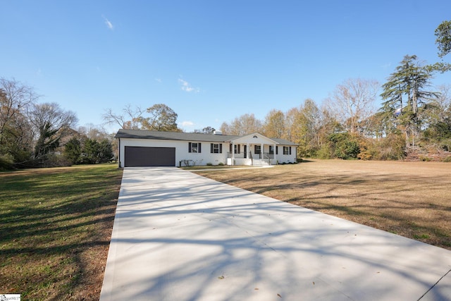 single story home featuring a front lawn and a garage