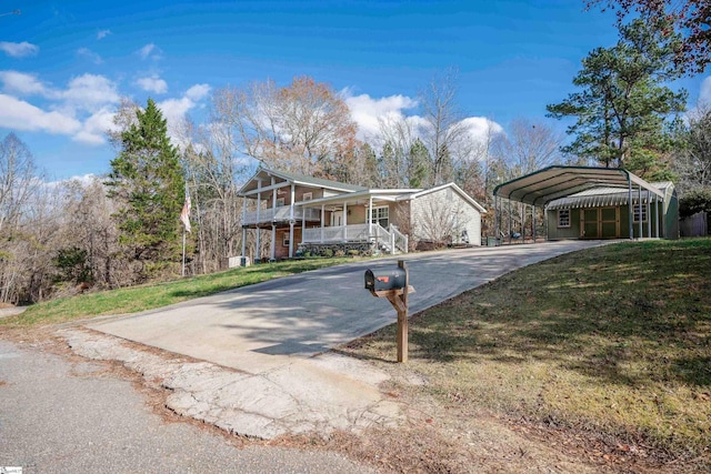 view of front of home featuring a front lawn, a porch, and a carport