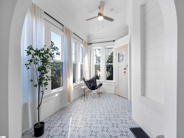 sunroom with plenty of natural light and ceiling fan