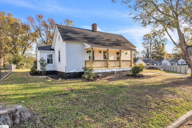 exterior space with covered porch and a front yard