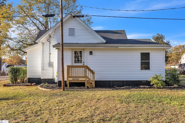 rear view of house with a lawn