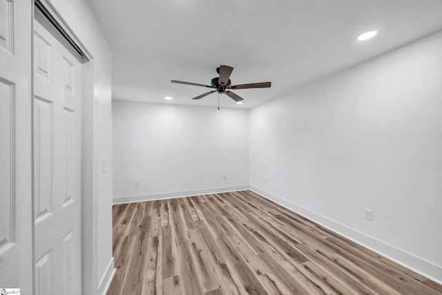 spare room featuring light hardwood / wood-style flooring and ceiling fan