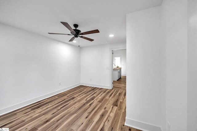 unfurnished room with hardwood / wood-style flooring and ceiling fan