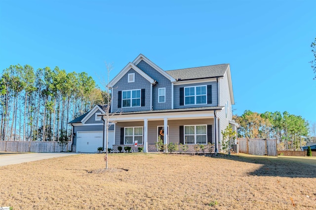 craftsman-style house with a front yard, a porch, and a garage