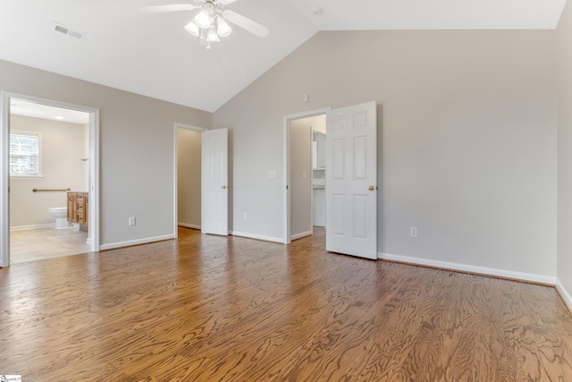 interior space featuring light wood-type flooring, high vaulted ceiling, ceiling fan, and connected bathroom