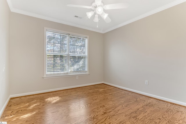 spare room with wood-type flooring, ceiling fan, and ornamental molding