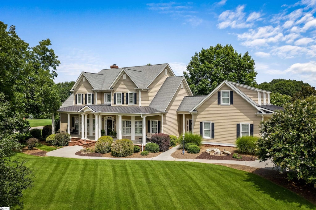 view of front facade with a front lawn and a porch