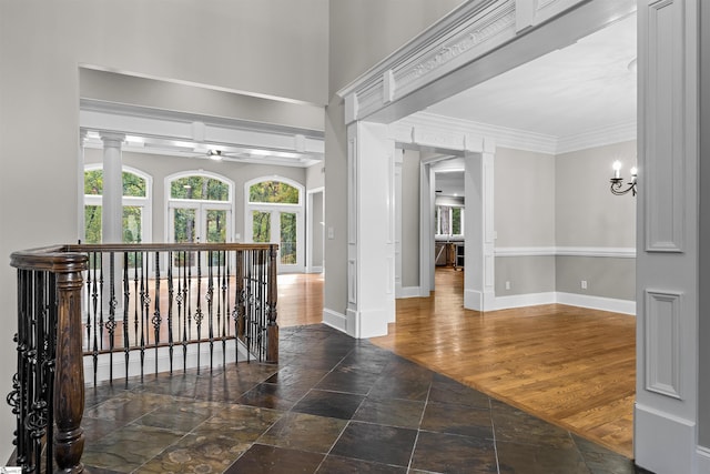 hall featuring crown molding, dark wood-type flooring, and a notable chandelier