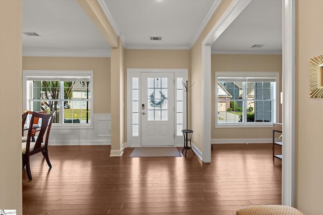 entryway featuring ornamental molding, dark hardwood / wood-style flooring, and a healthy amount of sunlight