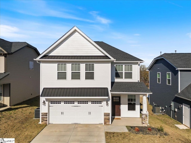 view of front facade with cooling unit, a garage, and a front yard