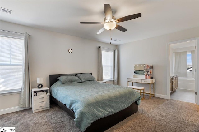 carpeted bedroom featuring ceiling fan and ensuite bathroom