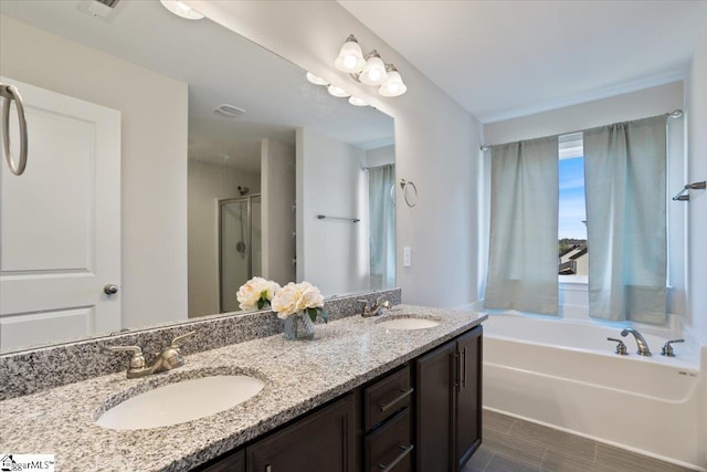 bathroom with vanity and independent shower and bath