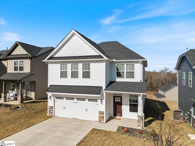 view of front of home featuring a garage and central air condition unit