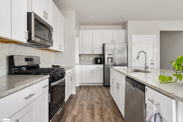 kitchen featuring light stone countertops, white cabinetry, sink, dark wood-type flooring, and appliances with stainless steel finishes