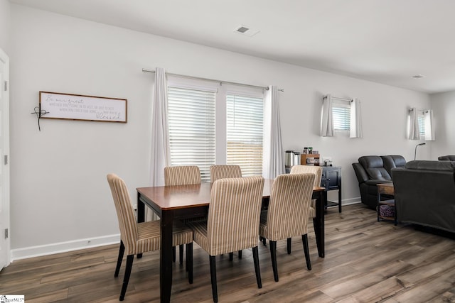 dining room with dark hardwood / wood-style floors