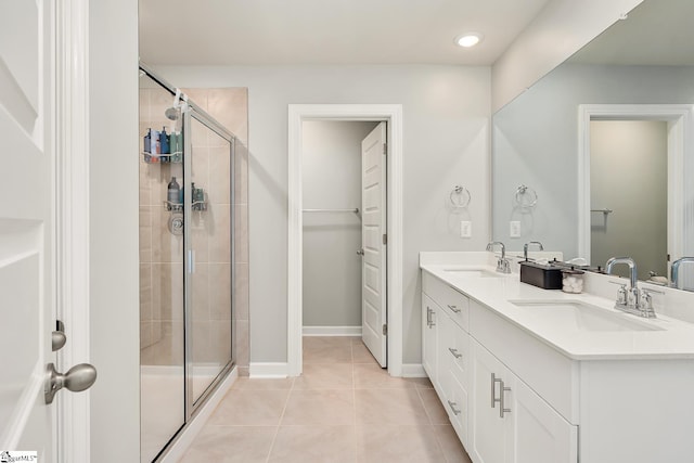 bathroom with tile patterned floors, vanity, and a shower with shower door