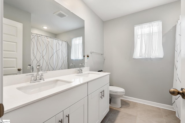 bathroom with tile patterned flooring, vanity, curtained shower, and toilet