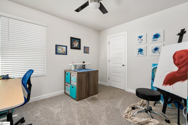 carpeted office featuring ceiling fan