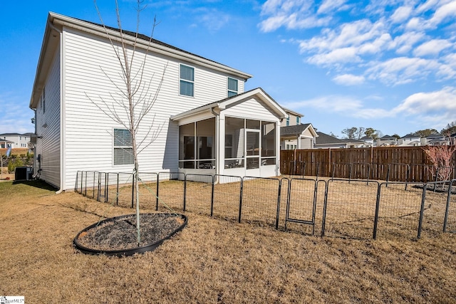 back of house with a sunroom, a yard, and central air condition unit