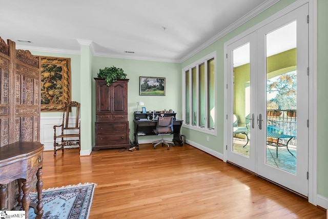 interior space with crown molding, french doors, and light hardwood / wood-style flooring