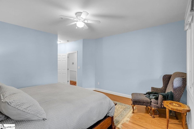 bedroom with hardwood / wood-style floors and ceiling fan