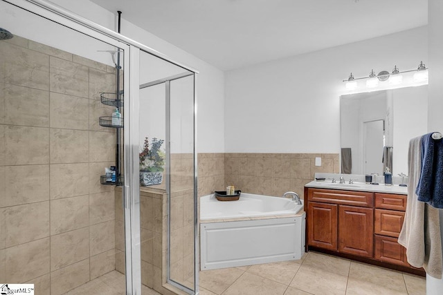 bathroom with tile patterned floors, vanity, and independent shower and bath