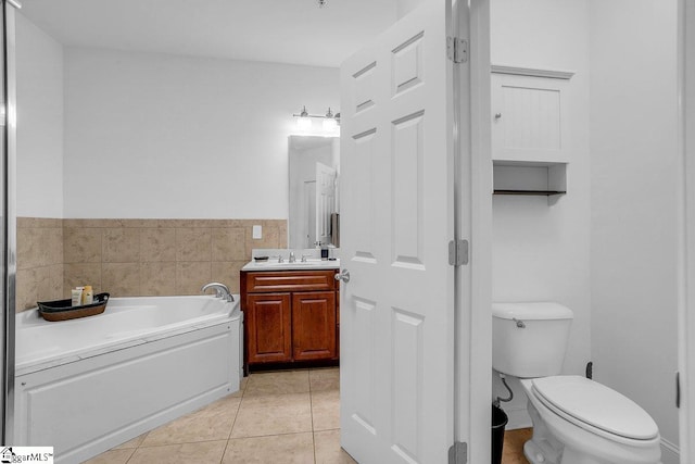 bathroom with tile patterned floors, vanity, a bath, and toilet