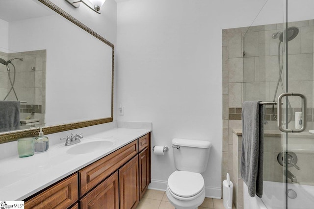 bathroom with toilet, vanity, tile patterned floors, and walk in shower