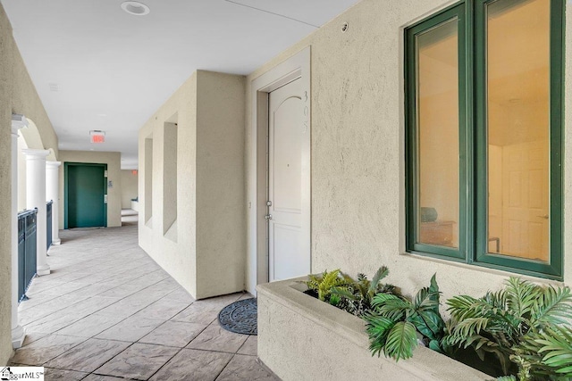 corridor with light tile patterned floors