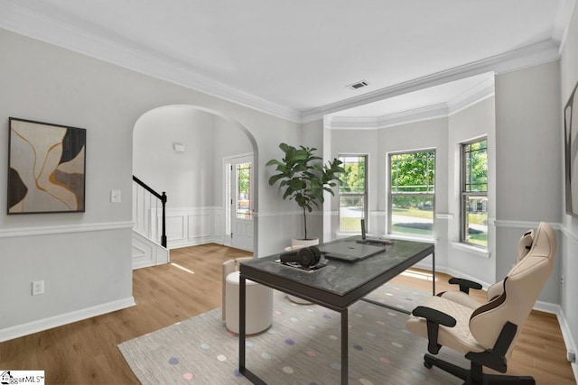 home office featuring plenty of natural light, light hardwood / wood-style floors, and ornamental molding