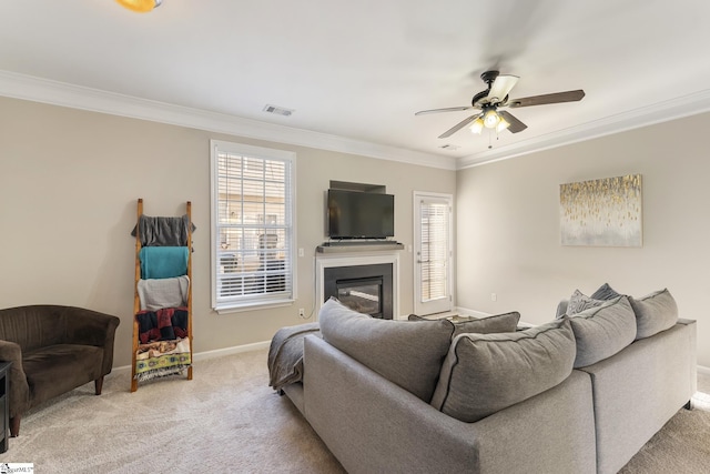 living room with light carpet, crown molding, and ceiling fan