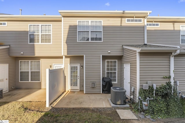 rear view of property with a patio area and central AC