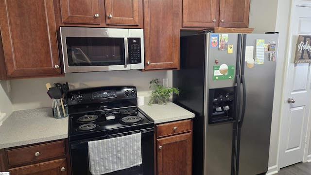 kitchen with stainless steel appliances and hardwood / wood-style flooring