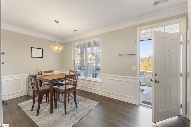 dining area with dark hardwood / wood-style flooring and ornamental molding