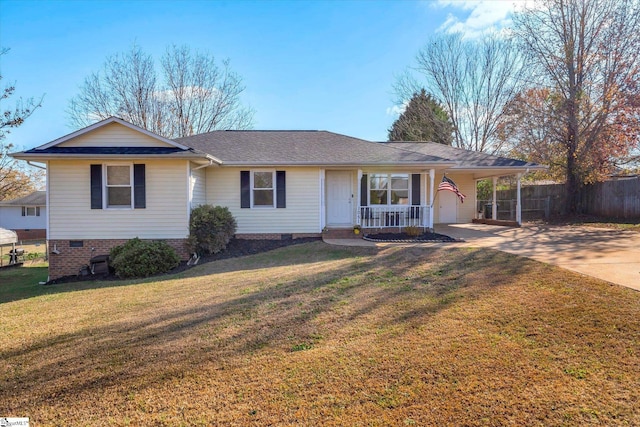 ranch-style home featuring a carport, covered porch, and a front yard