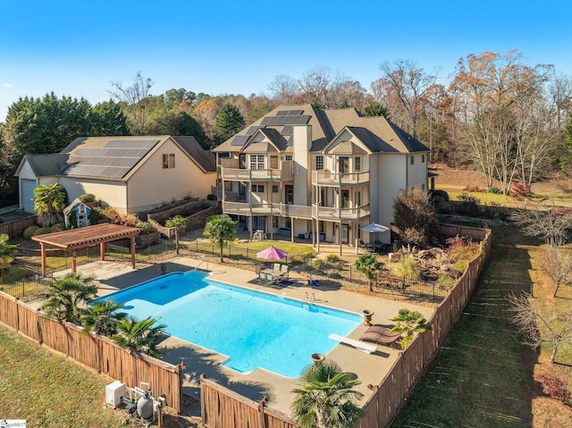 view of swimming pool with a pergola, a diving board, and a patio